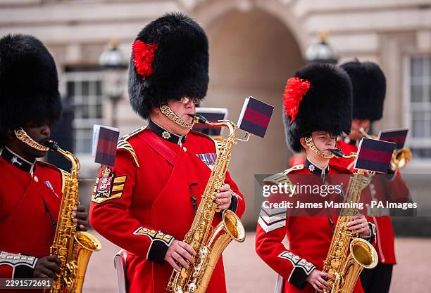 Members of the band of the Coldstream Guards and Welsh Guards play a tribute to singer Dolly Parton during the Changing the Guard at Buckingham...