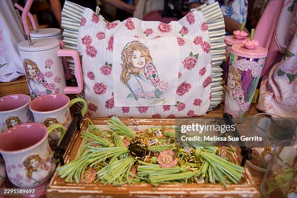 Dolly Parton themed items set on sale at Dollywood theme park on August 26, 2026 in Pigeon Forge, Tennessee. Fans of Dolly Parton have gathered at...