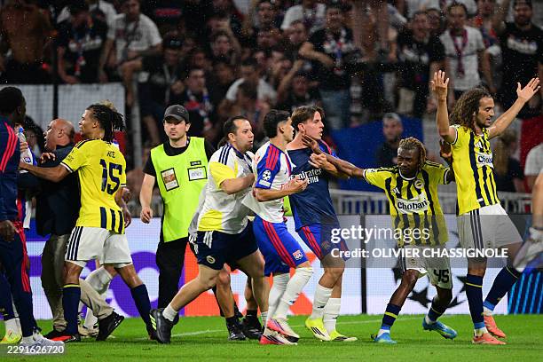 Fenerbahce's Malian forward Nene Dorgeles tried to seperate Fenerbahce's French midfielder Matteo Guendouzi and Lyon's players after the final...