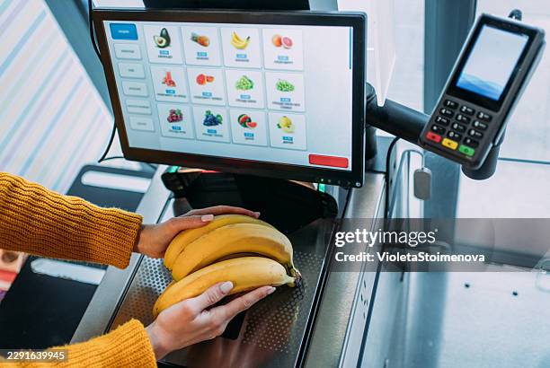 woman using self service checkout. - self service stock pictures, royalty-free photos & images