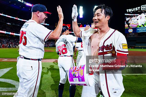 Ha-Seong Kim of the Atlanta Braves celebrates with teammates after hitting a walk-off single in the ninth inning during the game against the Los...