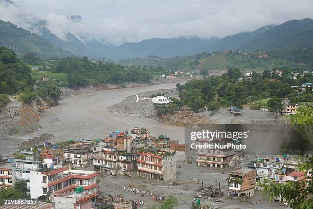 Damaged section of a highway in Nuwakot, central Nepal, is seen on August 27 following a glacial lake outburst in Tibet. Rescue teams collect bodies,...