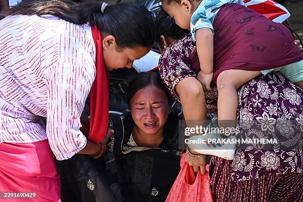 Woman breaks down as she waits for relatives to arrive at an army camp after being rescued from flash flood-affected areas, in Battar Bazar town in...