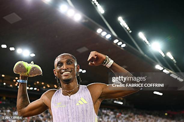 Brazil's Alison dos Santos celebrates after winning and breaking the world record in the men's 400m hurdles during the IAAF Diamond League athletics...