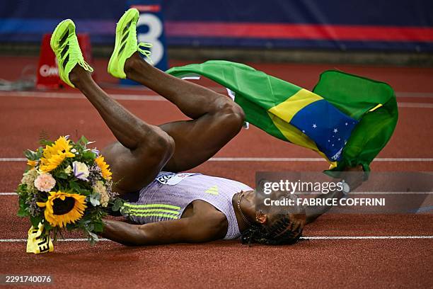 Brazil's Alison dos Santos celebrates after winning and breaking the world record in the men's 400m hurdles during the IAAF Diamond League athletics...