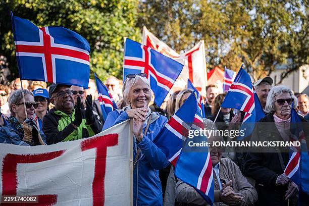 Supporters of the 'No' campaign wave Icelandic flags during a rally against reopening Iceland's European Union accession negotiations in Reykjavik,...