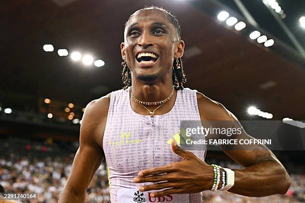 Brazil's Alison dos Santos celebrates after winning and breaking the world record in the men's 400m hurdles during the IAAF Diamond League athletics...