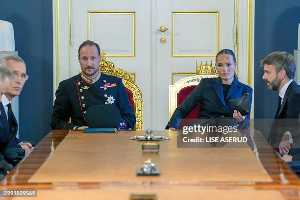 King Haakon of Norway and Princess Ingrid Alexandra of Norway sit at the head of the table for an extraordinary cabinet meeting at the Royal Palace,...