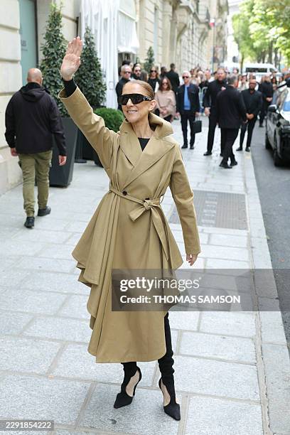 Canadian singer Celine Dion acknowledges fans as she arrives at Hotel Le Royal Monceau in Paris on August 28 ahead of he series of concerts in the...