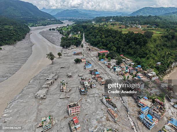 An aerial photo shows houses at a town along the Trishuli River destroyed by the flash floods, amid increasing deaths and missing people, in...