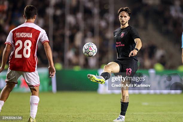 Ivan Lepinjica of Sabah is challenged by Niv Yehoshua of H. Beer-Sheva during the UEFA Champions League 2026/27 Play-offs 2nd leg between Sabah and...