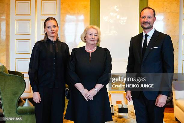Norway's new King Haakon VIII and Crown Princess Ingrid Alexandra poses with Chief Justice of the Supreme Court Toril Marie Oie in a condolence...