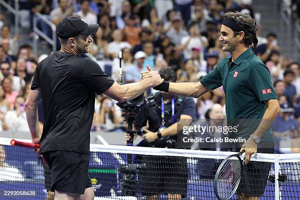 Roger Federer of Switzerland and Andy Roddick of the United States shake hands at the net after their exhibition singles match during Fan Week at the...