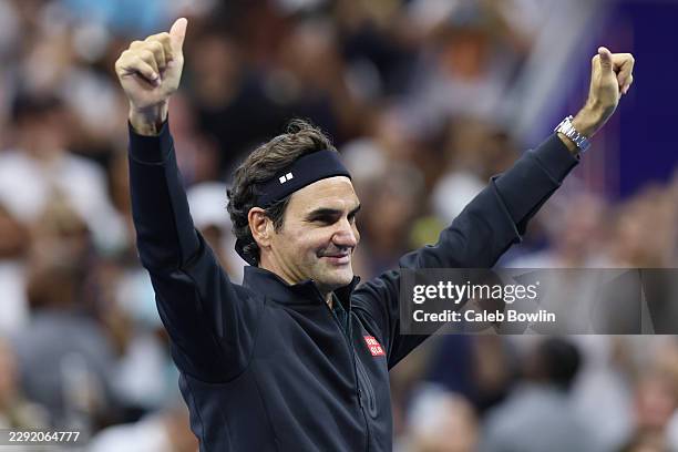 Roger Federer of Switzerland acknowledges the crowd after playing in the exhibition doubles match with John McEnroe of the United States against Andy...
