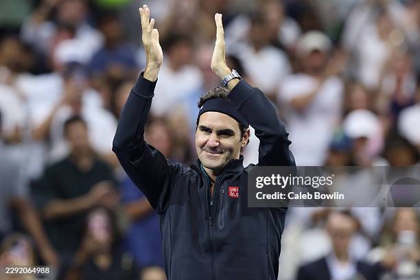 Roger Federer of Switzerland acknowledges the crowd after playing in the exhibition doubles match with John McEnroe of the United States against Andy...
