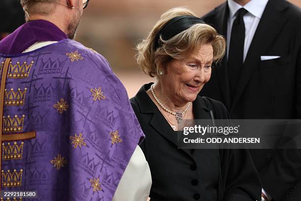 Norway's Queen Sonja walks past Dean Oyvind Stabrun as she leaves Asker Church after attending a memorial church service for her late husband, King...