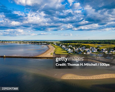 Scenic aerial view of a coastal town with a sandy beach and calm waters under a dramatic sky,Saco,United States,USA Scenic aerial view of a coastal town with a sandy beach and calm waters under a dramatic sky,Saco,United States,USA