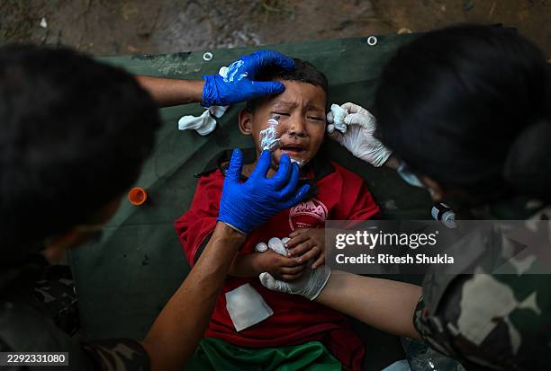 Rescue personnel provide medical treatment to a child at an army rescue camp in Trishuli Batar, Nepal, on August 27, 2026. A sudden flood swept...