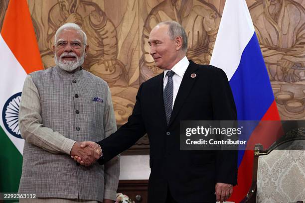 Russian President Vladimir Putin shakes hands with Indian Prime Minister Narendra Modi during the Shanghai Cooperation Organization Summit on August...