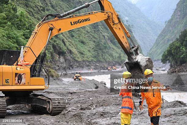 Excavators and loaders clear debris on a damaged road section leading to the Gyirong Port on August 28, 2026 in Gyirong, Xizang Autonomous Region of...