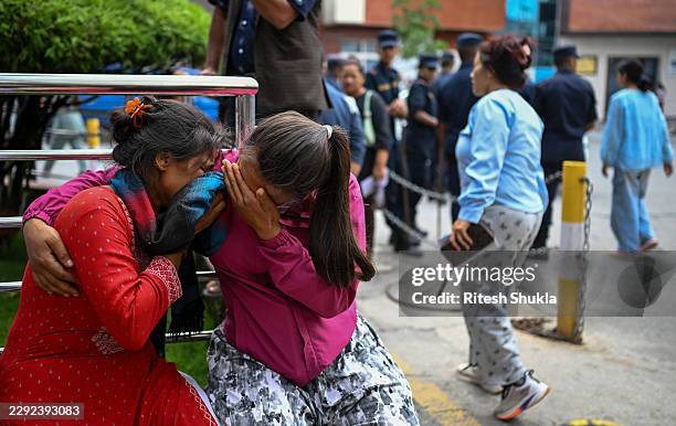 Family members of missing flood victims react at the emergency ward of the Maharajgunj Medical Campus, part of the Tribhuvan University Teaching...
