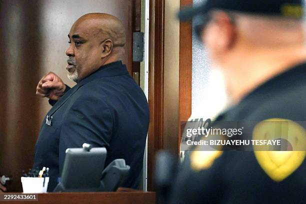 Duane Davis pumps his fist as he is led out of a courtroom after a jury found him guilty in the 1996 killing of rapper Tupac Shakur, in Clark County...