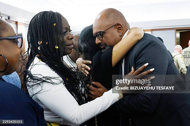Friends and family members of rapper Tupac Shakur, including his sister Sekyiwa Shakur, , line up to hug Chief Deputy District Attorneys Binu Palal...