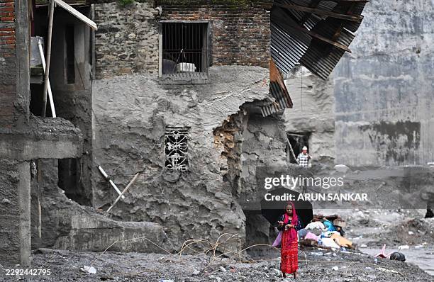 Woman walks among the ruins of flash floods in Nepal's Nuwakot district on September 1, 2026. The huge wave of freezing water and debris, sparked by...