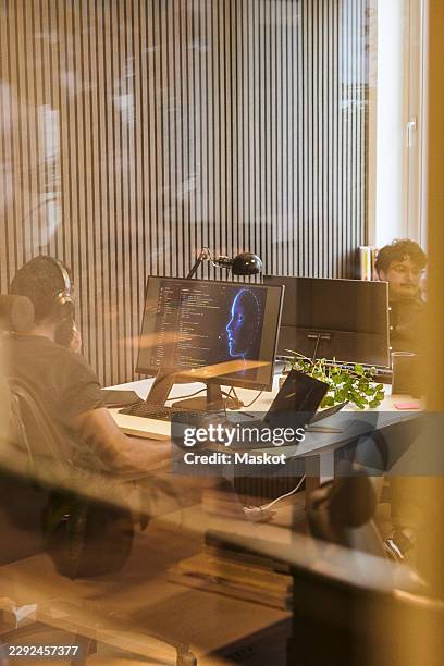 mature male programmer working on artificial intelligence software model in startup office - programmer working stock pictures, royalty-free photos & images