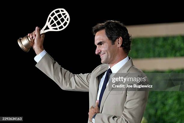 Inductee Roger Federer poses for a photo with his golden racquet following the International Tennis Hall of Fame 2026 Induction Ceremony on August...
