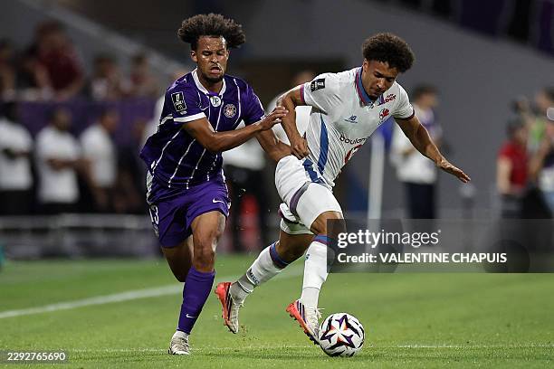 Toulouse's Canadian forward Jacen Russell-Rowe fights for the ball with Lille's Portuguese defender Tiago Santos during the French L1 football match...