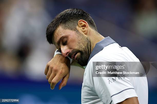 Novak Djokovic of Serbia reacts against Mariano Navone of Argentina during their Men's Singles First Round match on Day One of the 2026 US Open at...