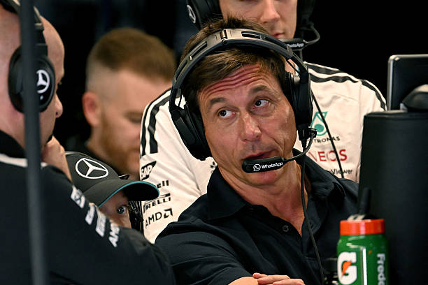 Mercedes' Austrian team principal and CEO Toto Wolff speaks with a team member during the first practice session of the Italian Formula One Grand...