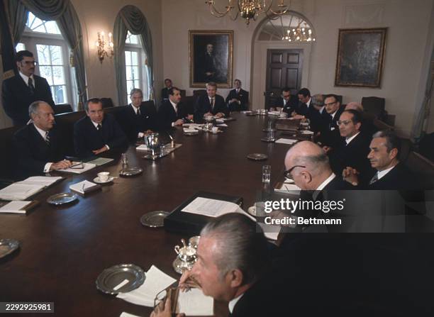 Visiting Italian Prime Minister Emilio Columbo sits directly across the table from President Nixon during a meeting in the Cabinet room at the White...