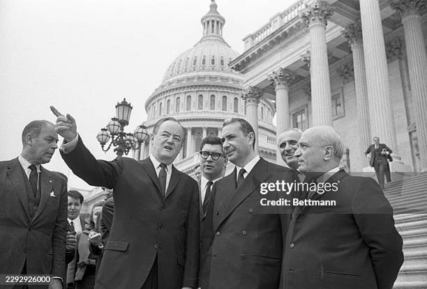 Vice President Hubert Humphrey points out some landmarks to visiting Italian Prime Minister Aldo Moro from the steps of the US Capitol. Left to...