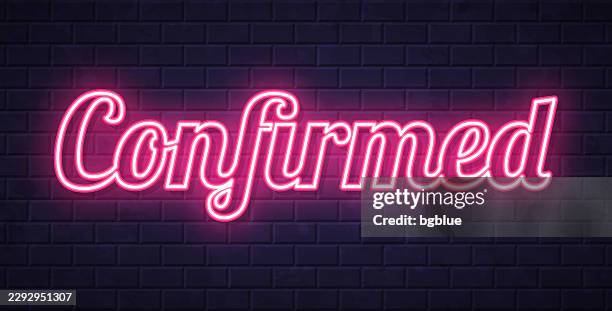 confirmed - glowing neon text on brick wall background - background verification stock illustrations