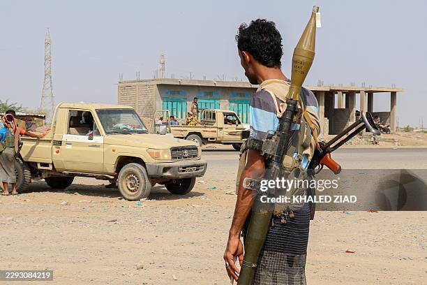 Forces loyal Yemen's Saudi-backed government stand near a pick-up truck in the Hays district, south of Hodeidah on September 5, 2026. Fighting...