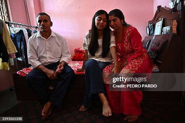 Flash flood survivor Santoshi Dotel and her parents, Raj Kumar Dotel and Durga Dotel, are seen after an interview with AFP at their home in Trishuli...
