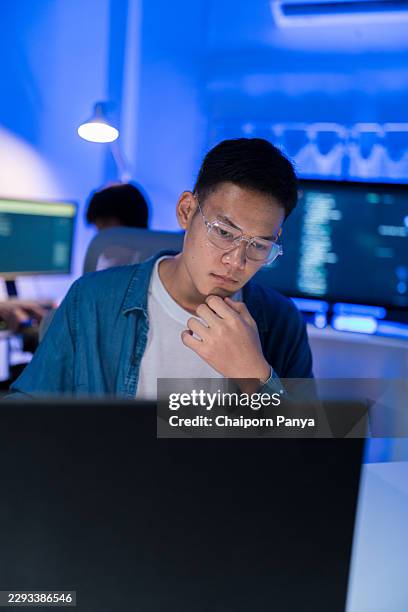 thoughtful programmer working on digital technology - web programmer stock pictures, royalty-free photos & images
