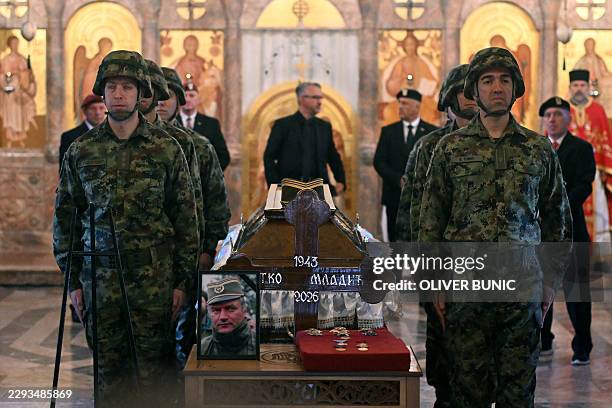 Serbian armed forces stand guard as Darko Mladic stands in front of the coffin of his father while taking part in a public memorial on the day of the...