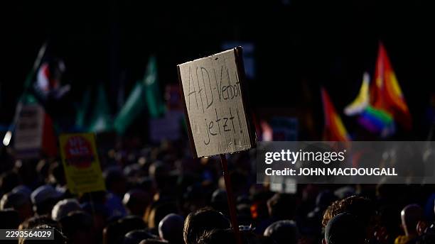 People protest and hold a placard reading "Prhibit the AfD now!" during a rally called by the organizations Campact and Fridays for Future named...