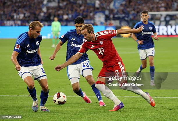 Harry Kane of Bayern Munich is challenged by Timo Becker of FC Schalke 04 during the Bundesliga 2026/27 match between FC Schalke 04 and FC Bayern...