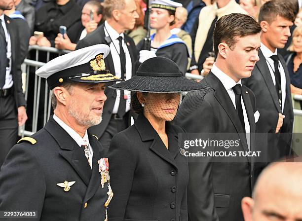 King Frederik X of Denmark, Queen Mary of Denmark and Crown Prince Christian of Denmark walk as the casket of late King Harald V of Norway is...