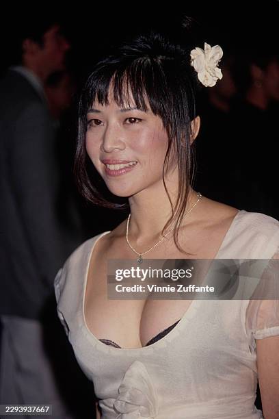 American actress Lauren Tom, wearing a white scoop-neck dress, attends the 8th Annual California Fashion Industry Friends of APLA Benefit Dinner &...