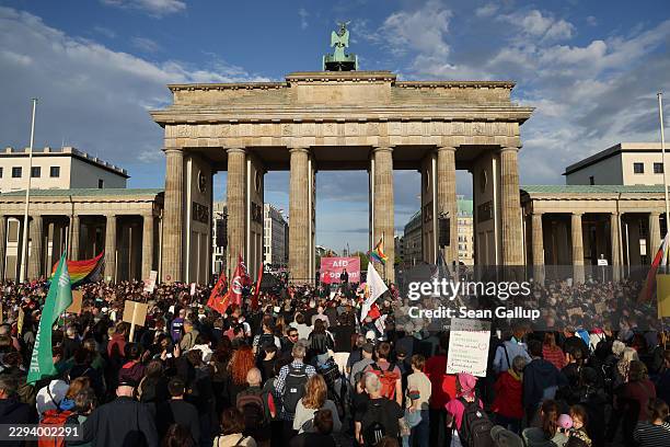 People gather in front of the Brandenburg Gate to protest against the far-right Alternative for Germany the day after the AfD won in Saxony-Anhalt...