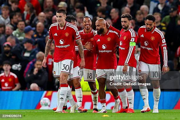 Manchester, United Kingdom Benjamin Sesko of Manchester United celebrates after scoring his team's third goal with teammates during the UEFA...