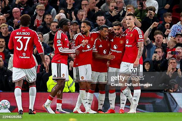Manchester, United Kingdom Benjamin Sesko of Manchester United celebrates after scoring his team's third goal with teammates during the UEFA...