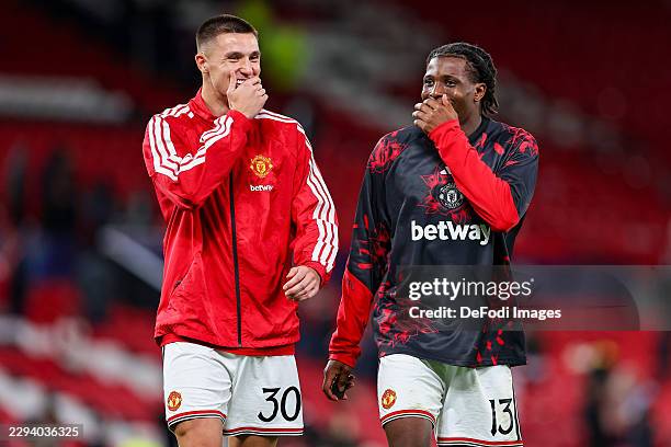 Manchester, United Kingdom Benjamin Sesko of Manchester United and Patrick Dorgu of Manchester United talk together during the UEFA Champions League...