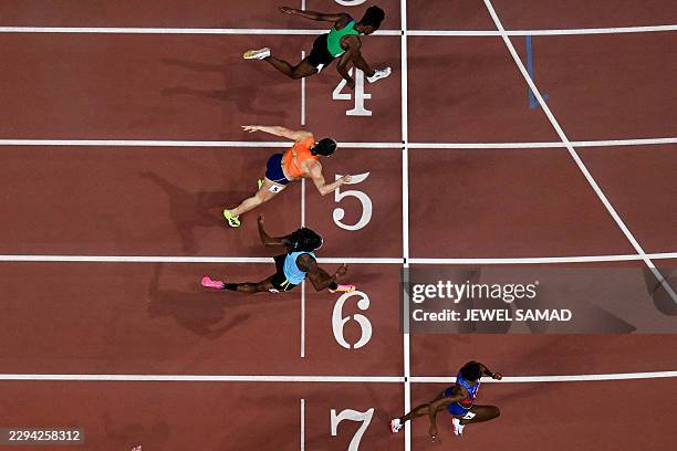 Masai Russell crosses the finish line ahead of Nigeria's Tobi Amusan, Netherlands' Nadine Visser, and Bahamas' Devynne Charlton during the women's...
