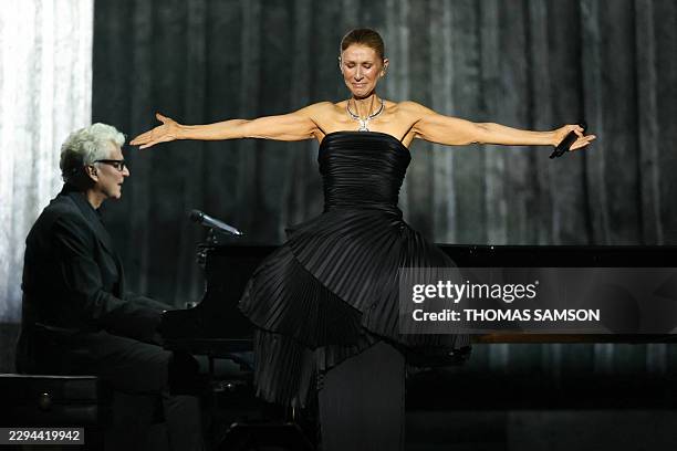 Canadian singer Celine Dion reacts as she performs during her first concert of a series at the Plenitude Arena in Nanterre, west of Paris on...